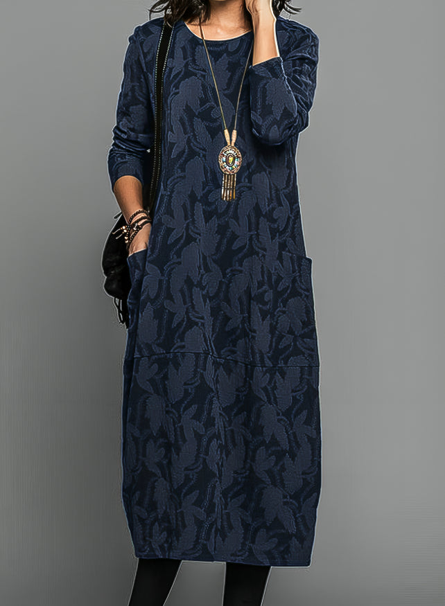 Women's casual midi dress with long sleeves, side pockets, and patterned hem in versatile everyday style