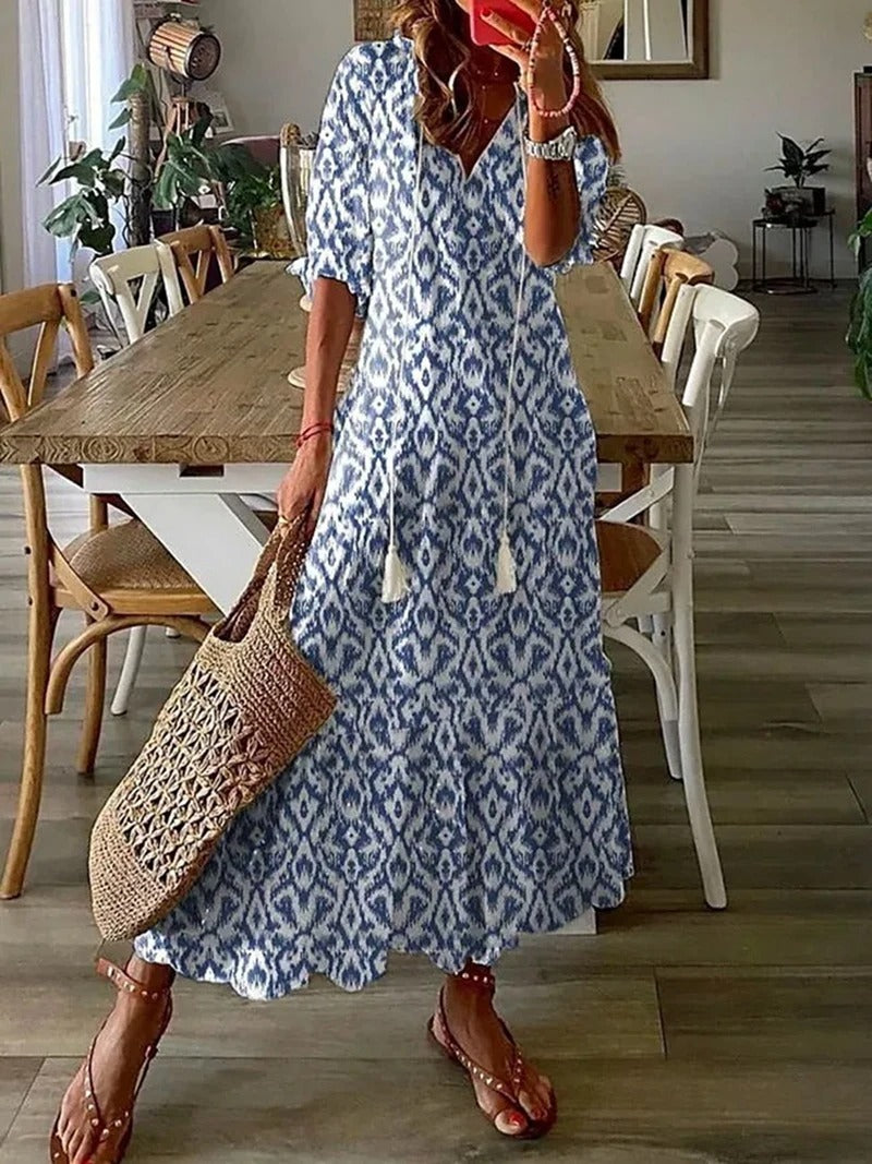 Flowy bohemian midi dress with three-quarter sleeves, relaxed silhouette and casual elegant style