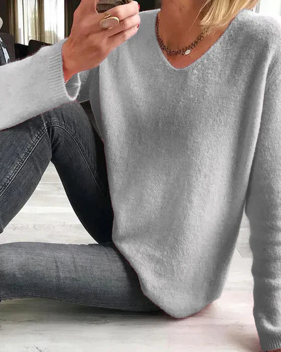 Solid long sleeve minimalist sweater in neutral tone, soft knit fabric, clean lines for casual and elegant wear