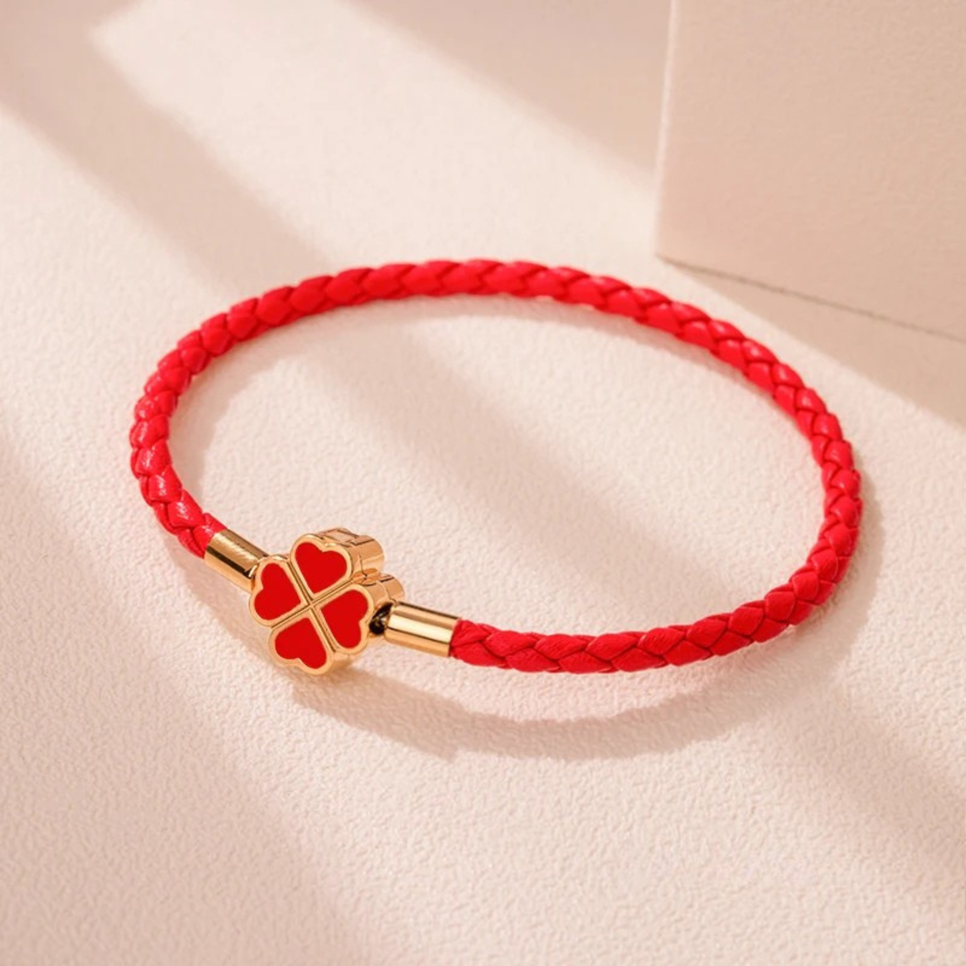 Hand-braided cowhide leather bracelet with 18K gold four-leaf clover charm, hypoallergenic tarnish-resistant