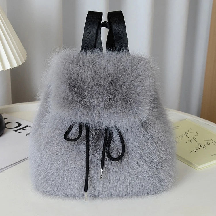 Women's plush faux fur backpack with drawstring closure and magnetic snap, roomy fashion-forward design