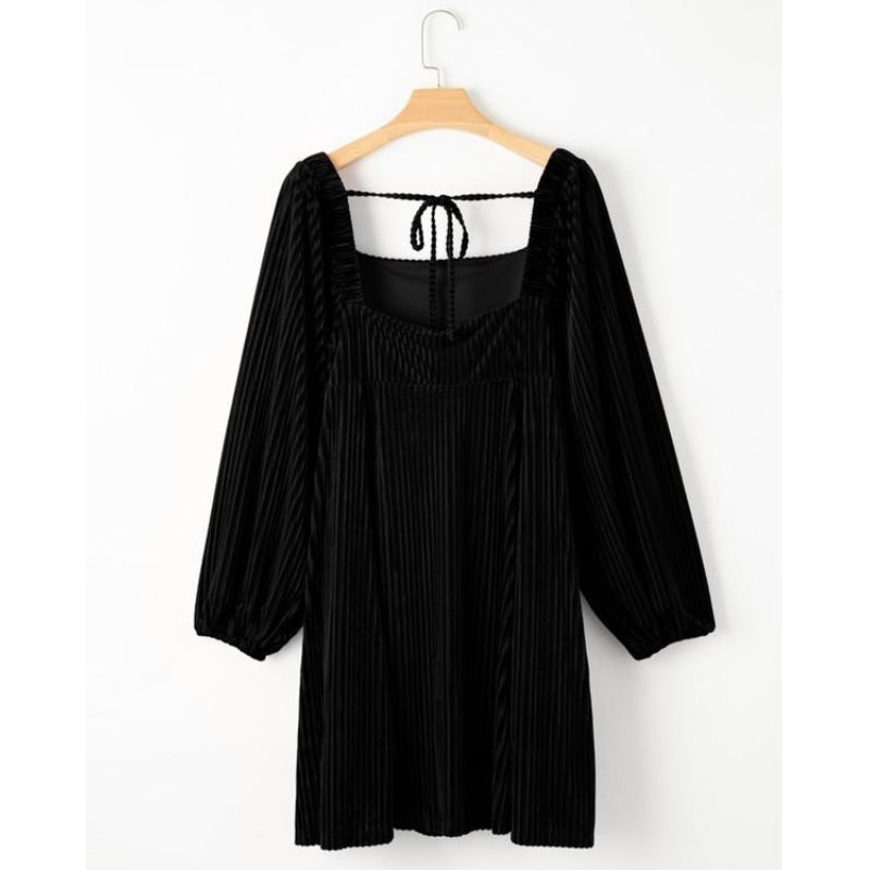 Emerald green velvet mini dress with structured square neckline and vertical pleats for nights out