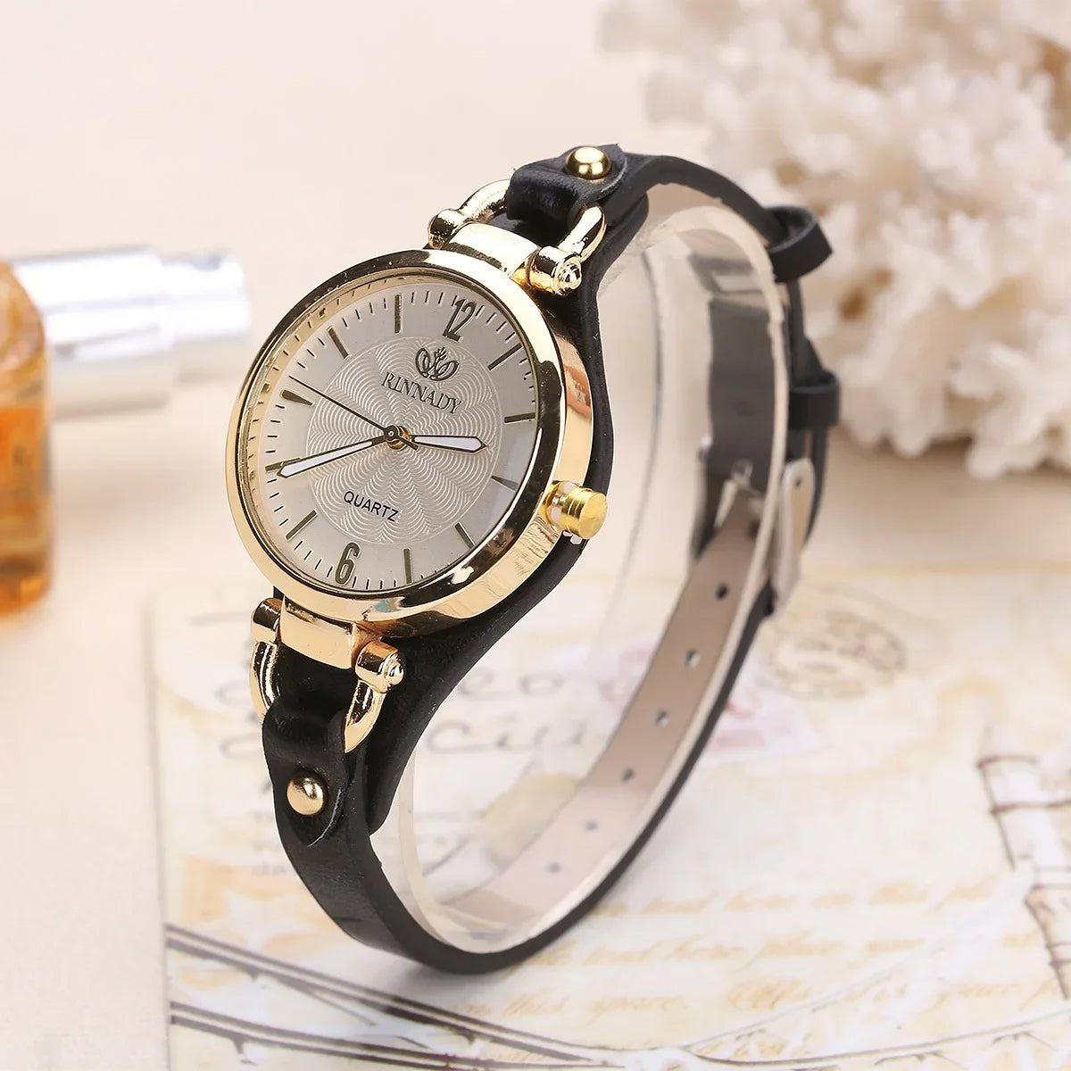 Minimalist quartz watch gold-tone bezel etched dial vegan leather strap vintage-inspired elegance