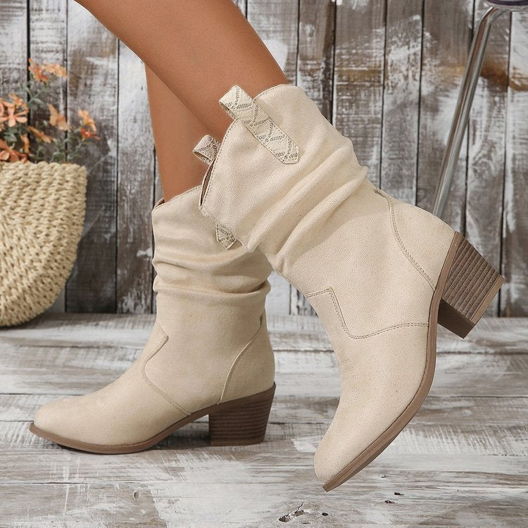 Brown leather western ankle boots with tassel detail, braided buckle accent, and stacked heel