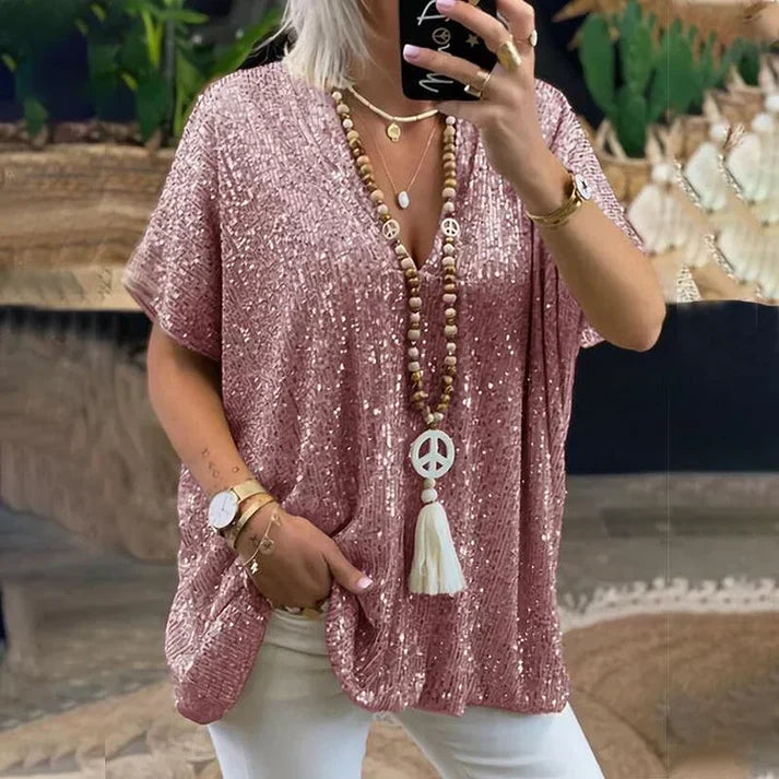 Women's silver sequin V-neck blouse with sparkling embellishment, flattering neckline for evening wear