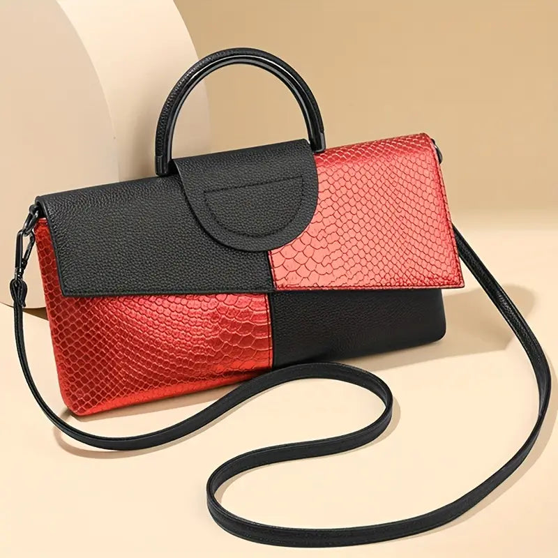 Black structured vegan leather handbag with bold faux snakeskin embossed texture and detachable strap