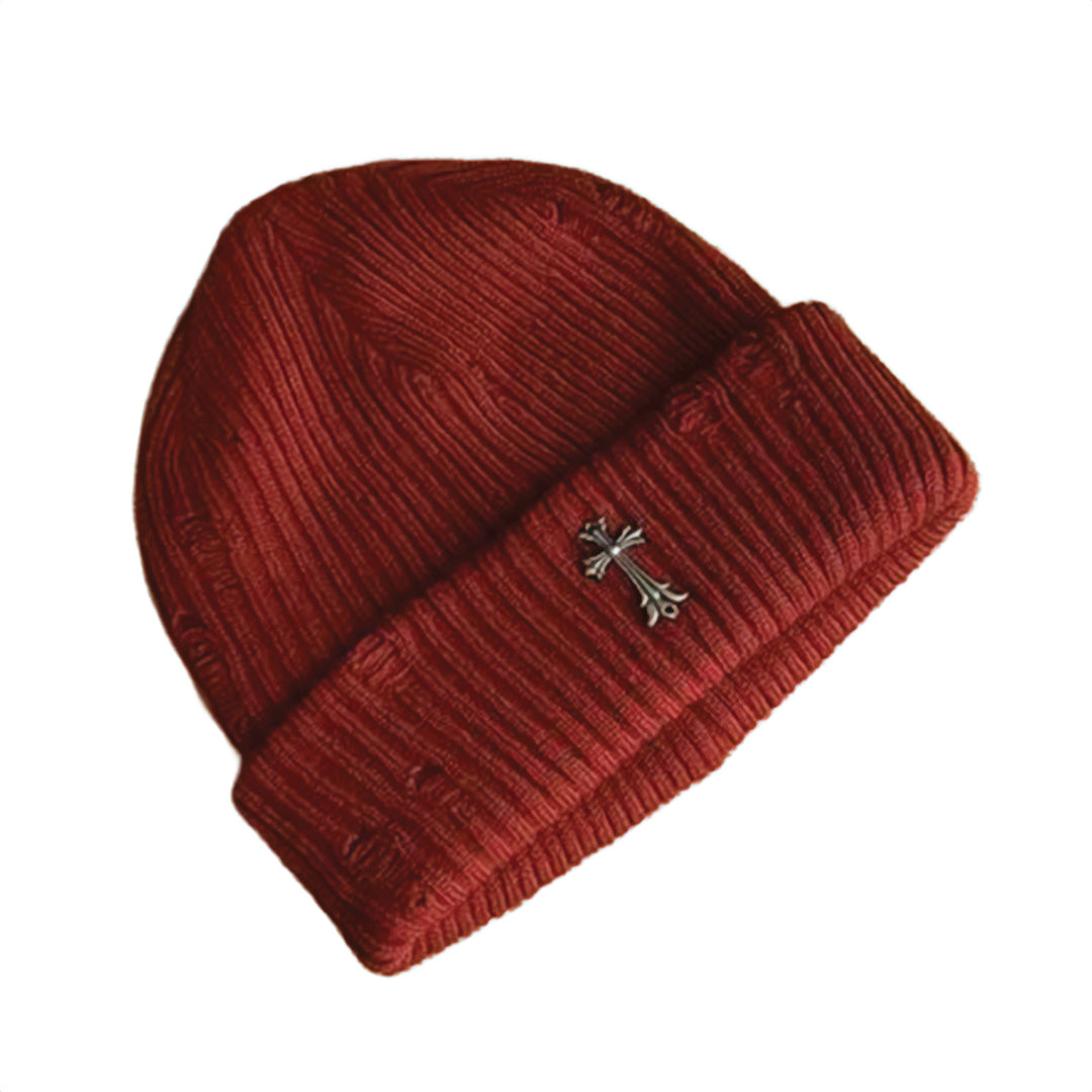 Black ribbed knit beanie with distressed finish and bold iron cross metal emblem for streetwear