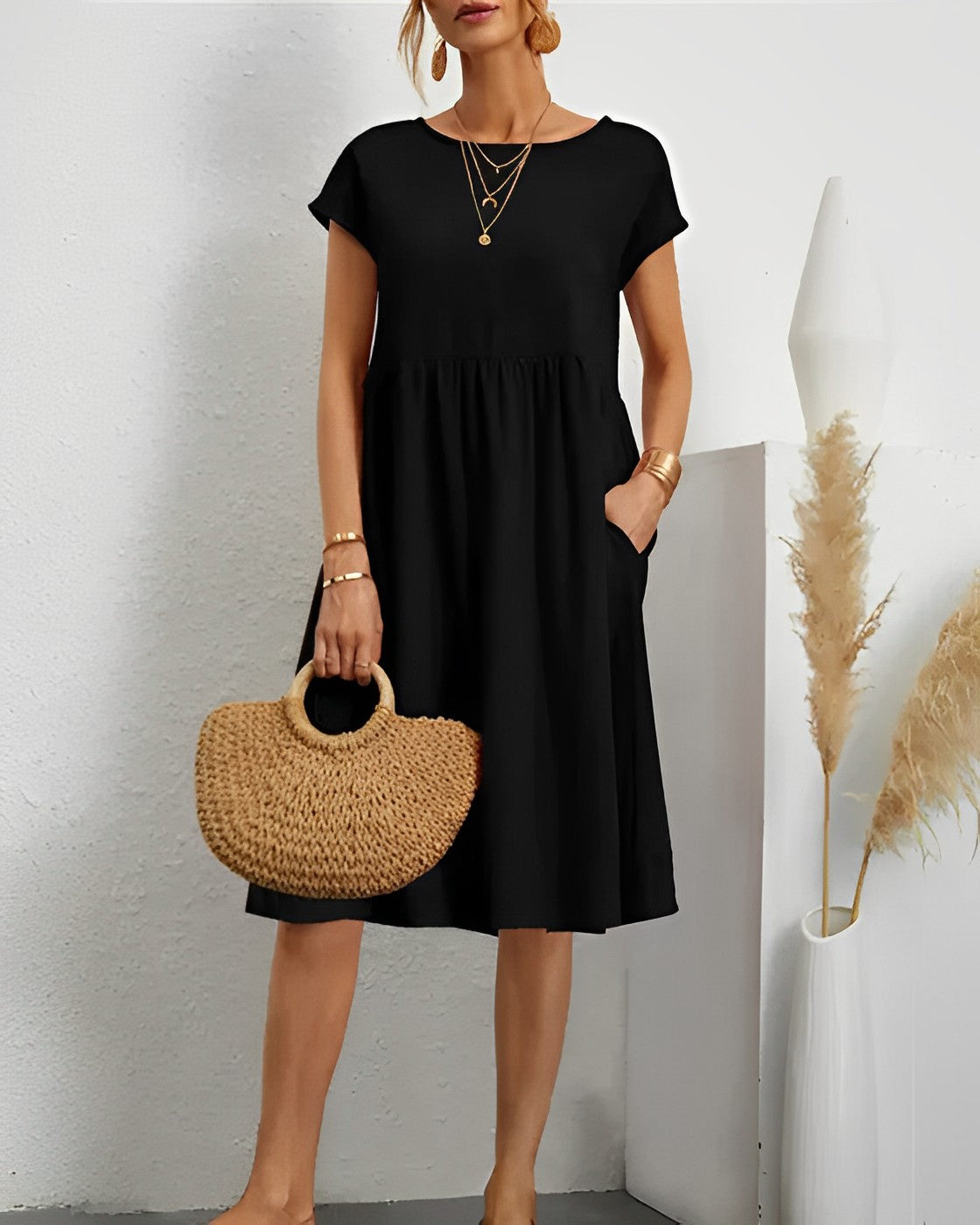 Women's loose-fit midi dress with short sleeves, round neck, and side pockets for effortless everyday style