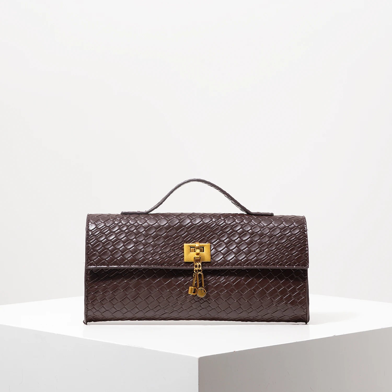 Venezia handwoven vegan leather baguette clutch with gold lock detailing, compact day-to-night style