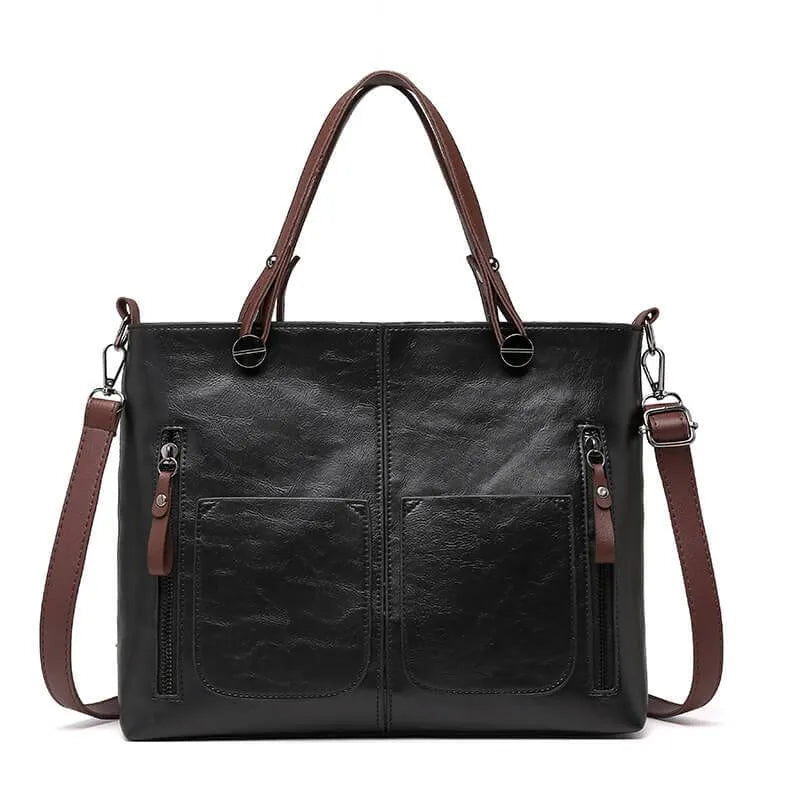 Structured vegan leather boxy tote handbag with smooth texture and multiple pockets for professionals