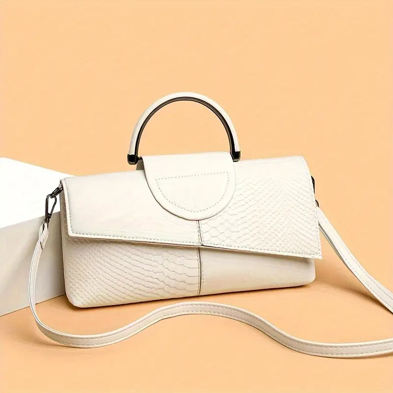 Black structured vegan leather handbag with bold faux snakeskin embossed texture and detachable strap