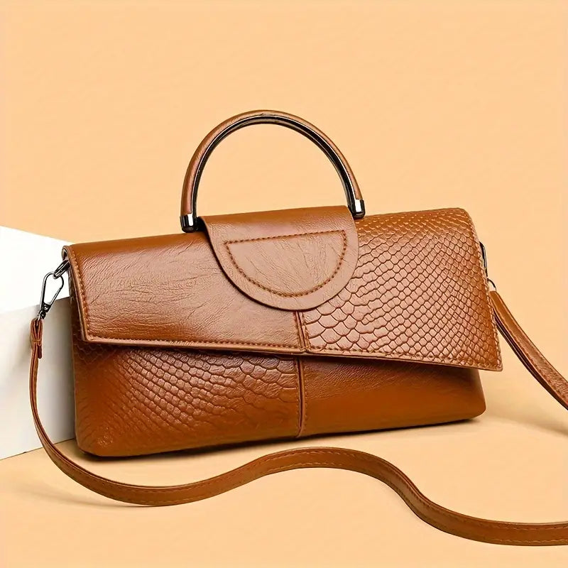 Black structured vegan leather handbag with bold faux snakeskin embossed texture and detachable strap