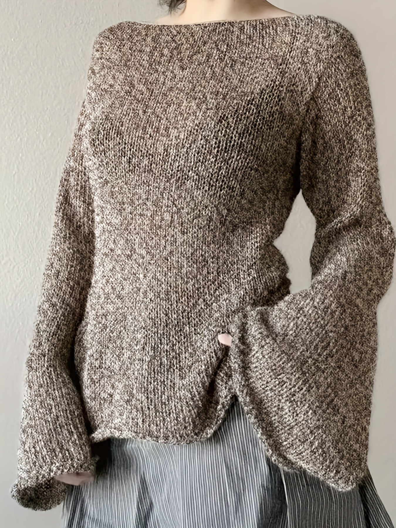 Women's minimalist knit sweater with elegant flared draped sleeves in soft warm tones