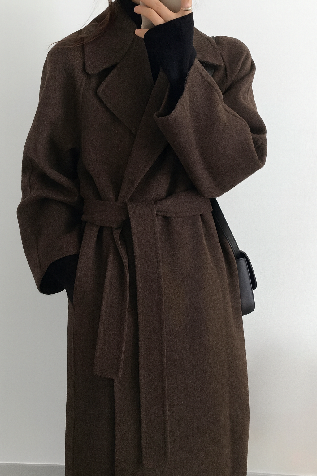 Women's long belted wrap coat elegant winter silhouette with waist-defining tie for workwear