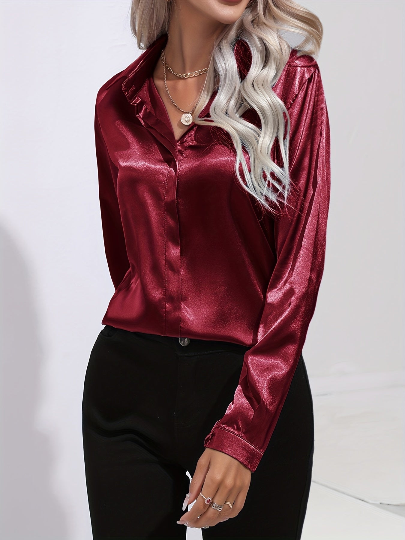Women's white long-sleeve button-up blouse with classic collar and shiny finish for office