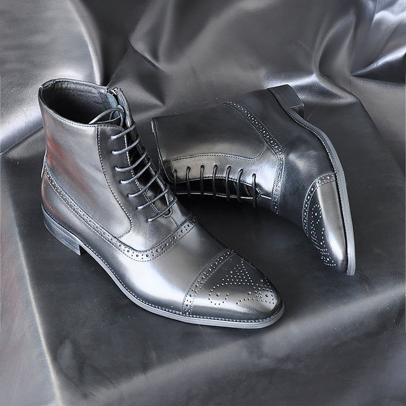 Men's black leather cap-toe brogue boots with side zip and polished lace-up dress silhouette
