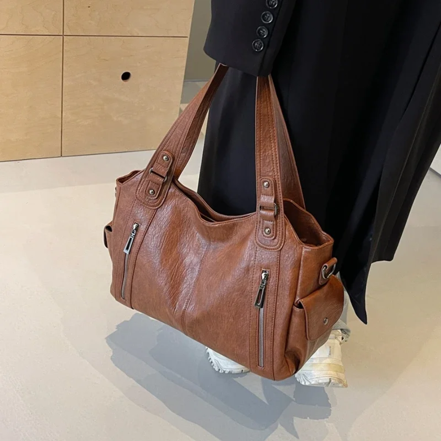 Élise black faux leather duffle shoulder bag with multiple zip compartments for women