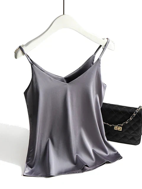 Women's ivory satin cami top with deep V-neck, thin straps, and silky luxurious drape