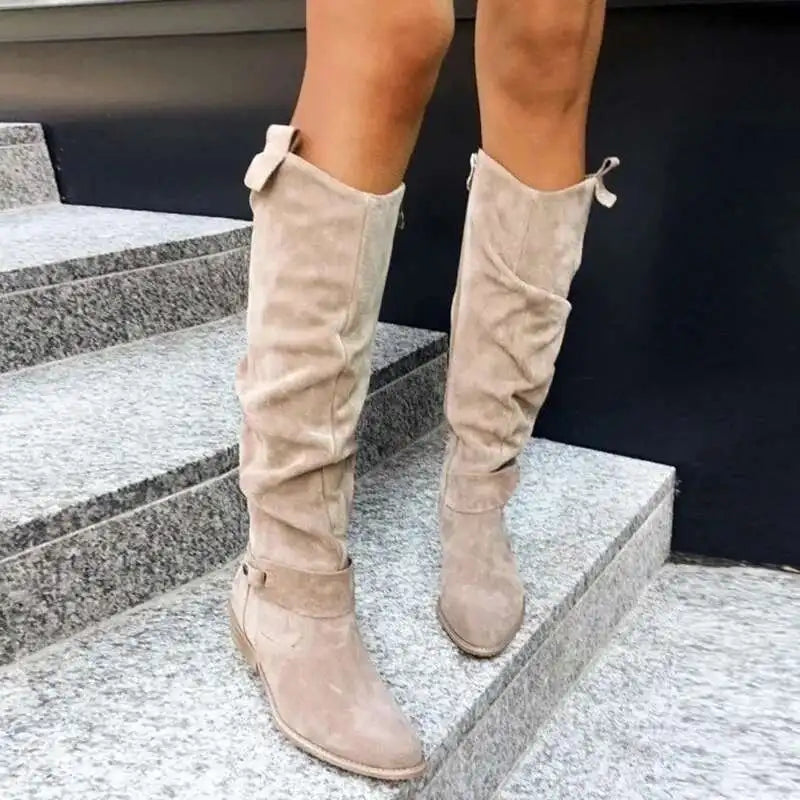 Women's brown suede knee-high slouchy boots with elegant strap detailing and relaxed silhouette