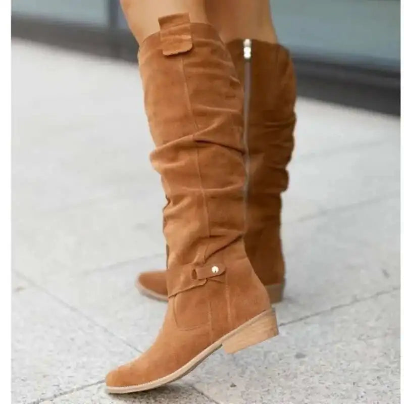 Women's brown suede knee-high slouchy boots with elegant strap detailing and relaxed silhouette