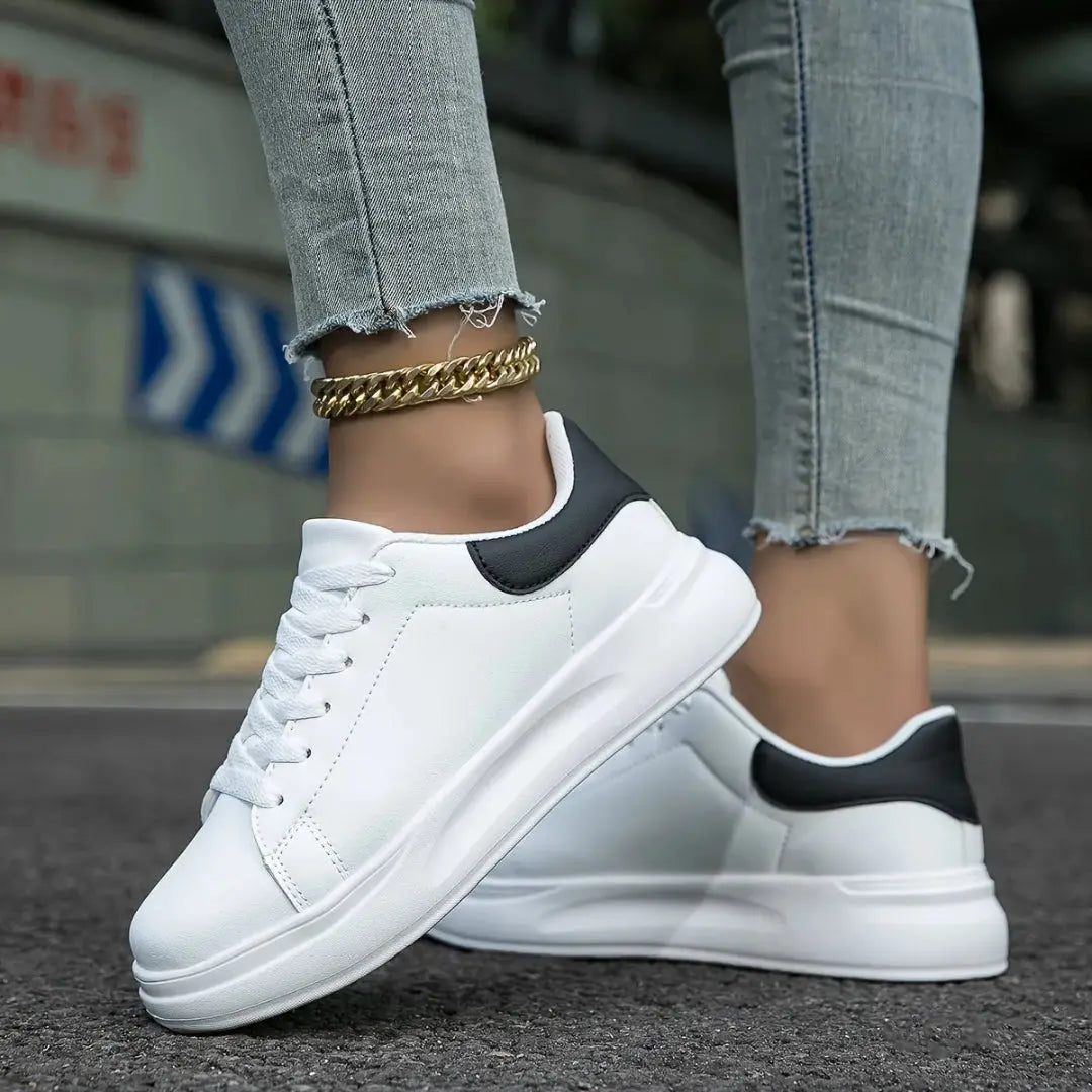 White low-top platform sneakers with clean silhouette and elevated sole for urban streetwear