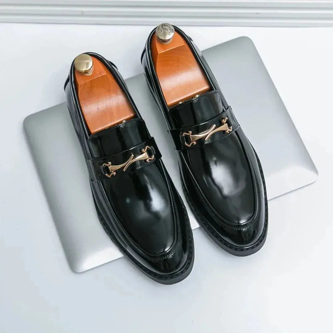 Black patent leather loafers with gold bit detailing, sleek modern cut for professional style