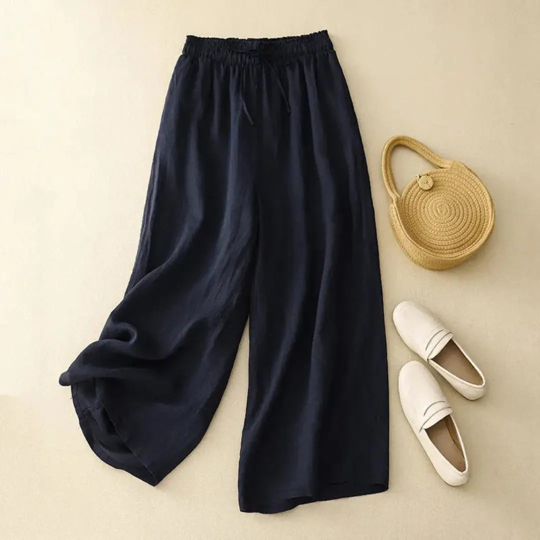 Women's beige linen high-waist wide-leg pants with elastic drawstring waistband, flowy silhouette