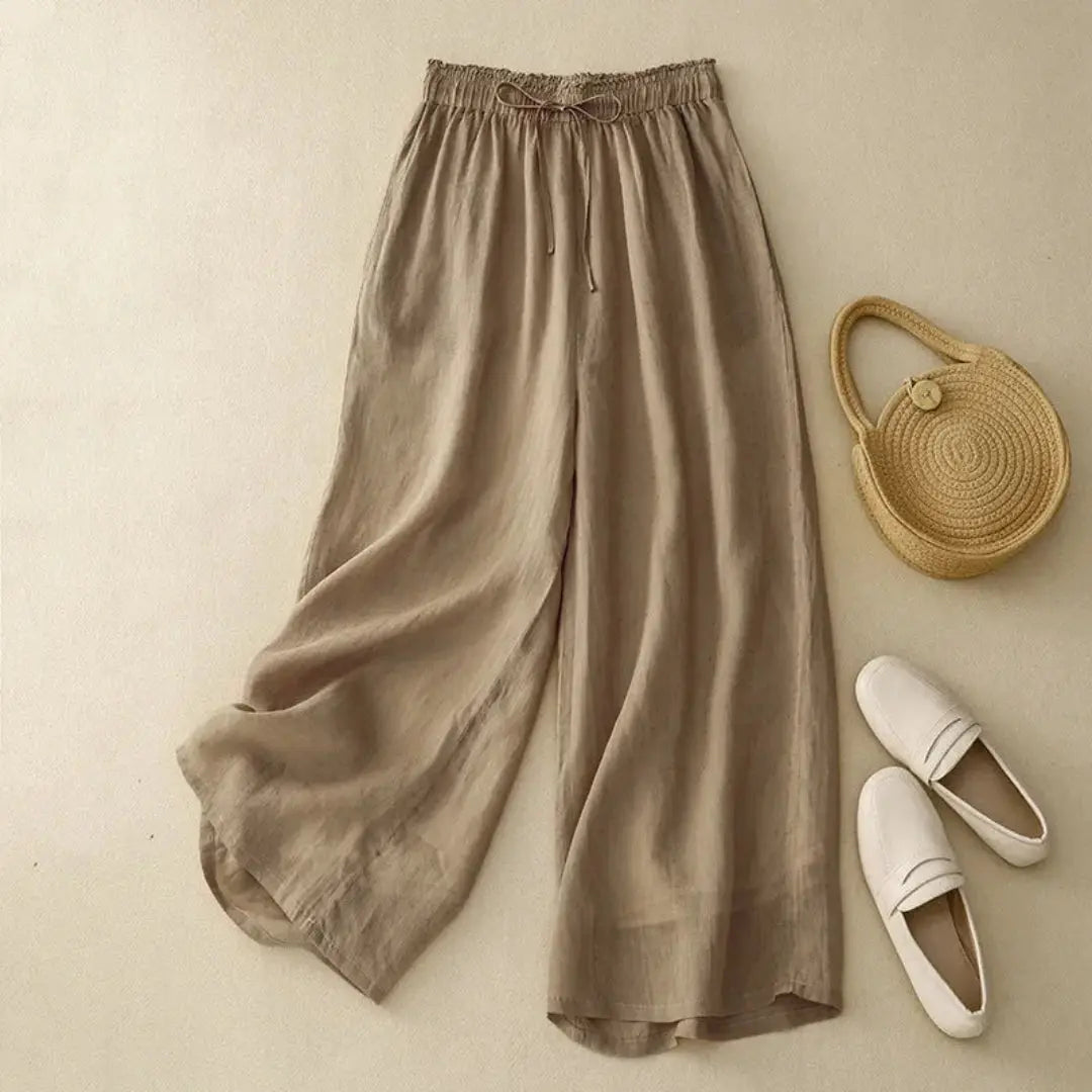 Women's white linen high-waist wide-leg pants with elastic drawstring waistband, flowy silhouette