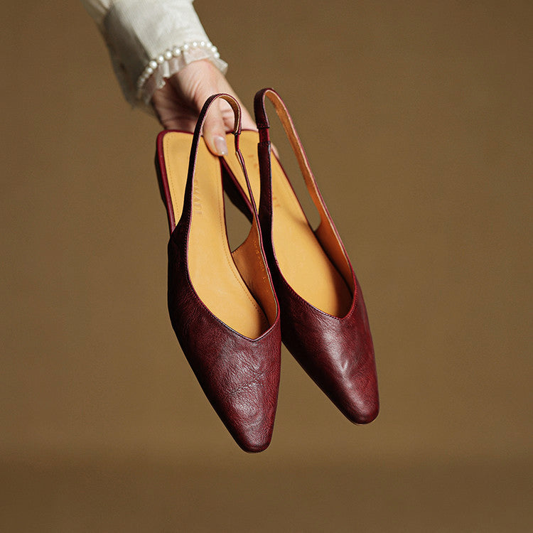 Women's pointed toe slingback flats in faux leather with sleek silhouette and secure ankle strap
