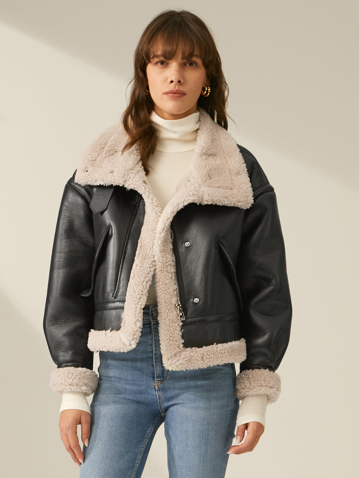 Women's black faux leather flight jacket with plush sherpa lining, classic silhouette for urban style
