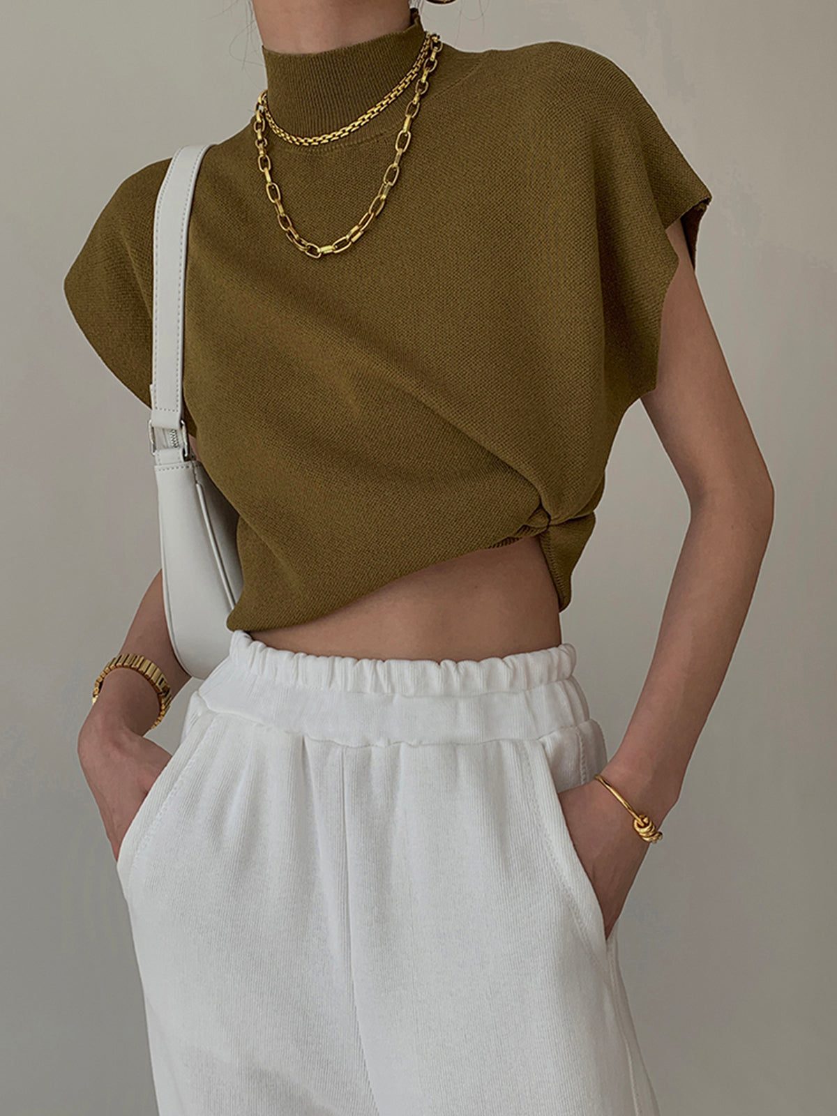 Beige sleeveless knit vest mock neck slim fit lightweight layering piece for office and casual wear