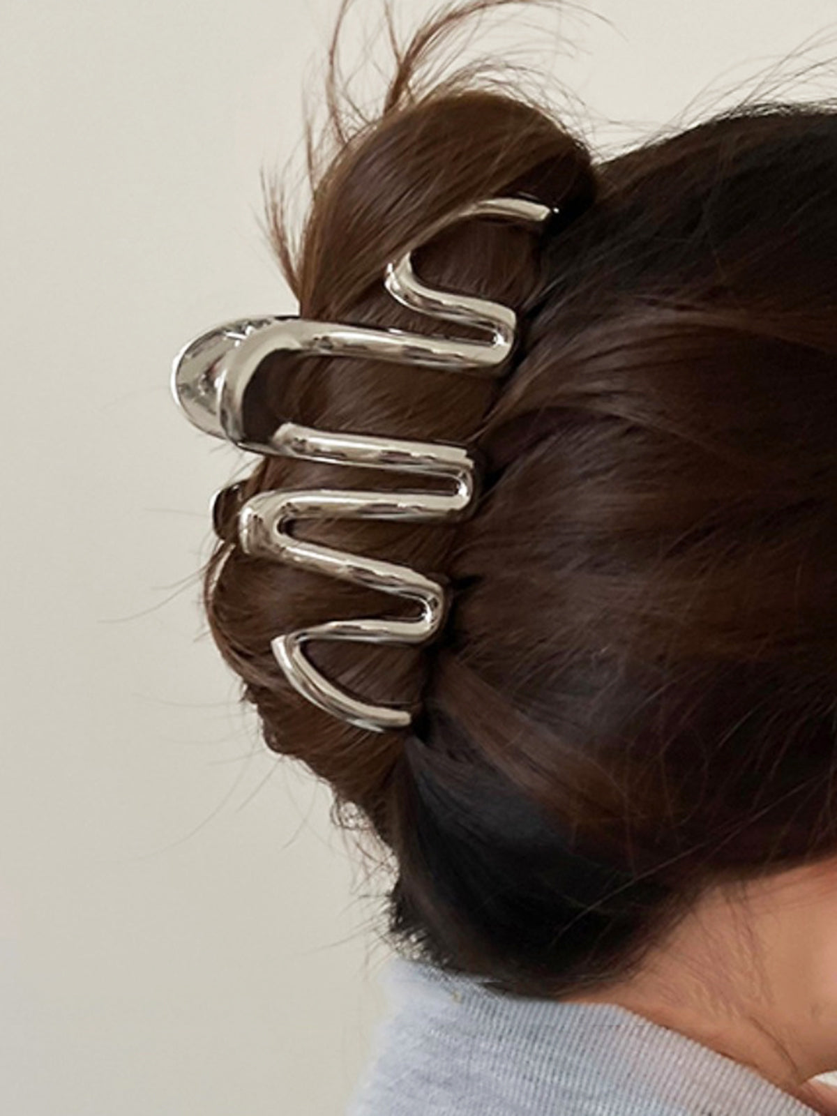 Silver glossy wave hair claw clip sculptural design secure hold polished everyday updo