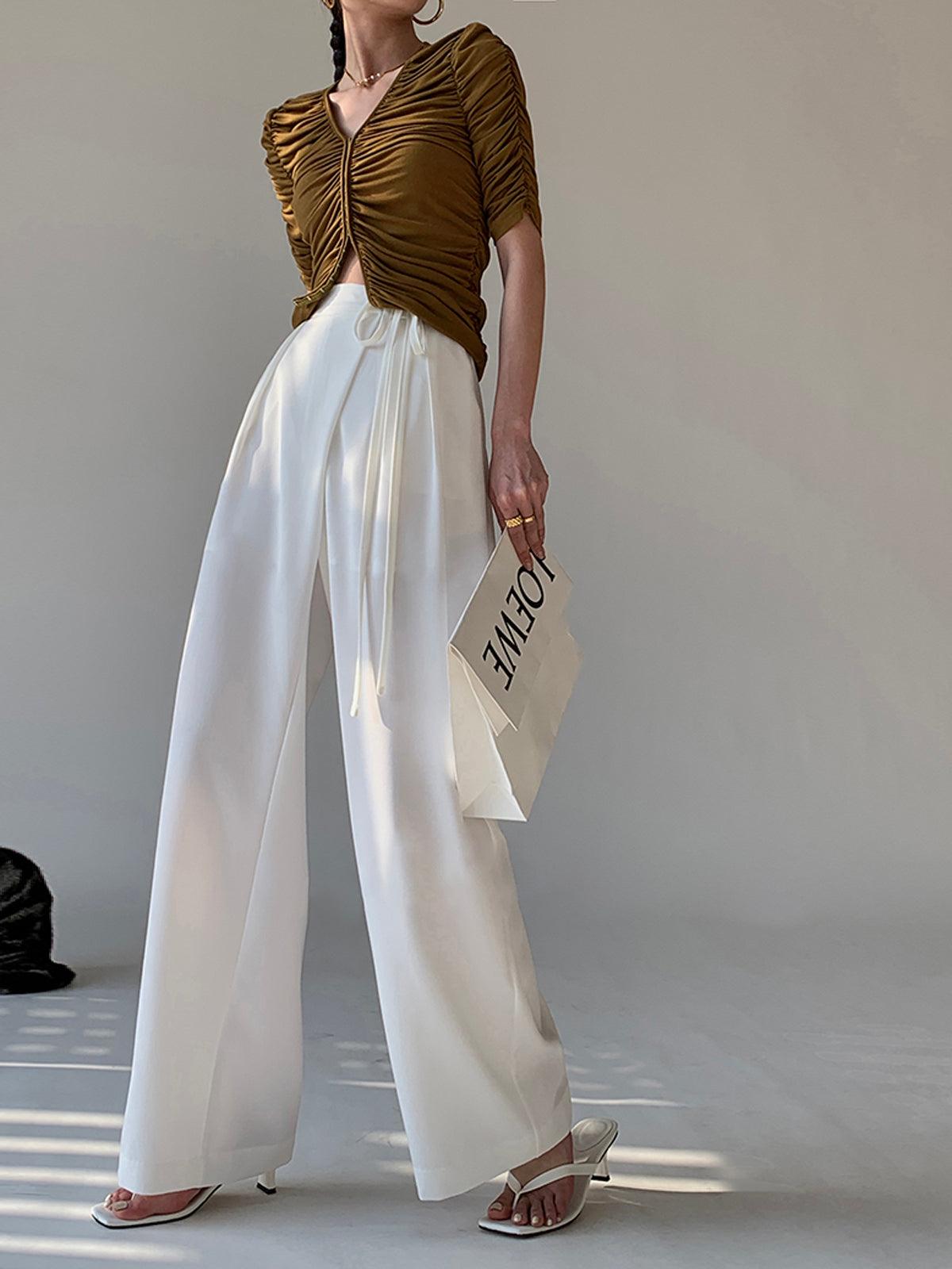 Women's flowy wide-leg pants in neutral tone with elegant tie waist and casual chic silhouette