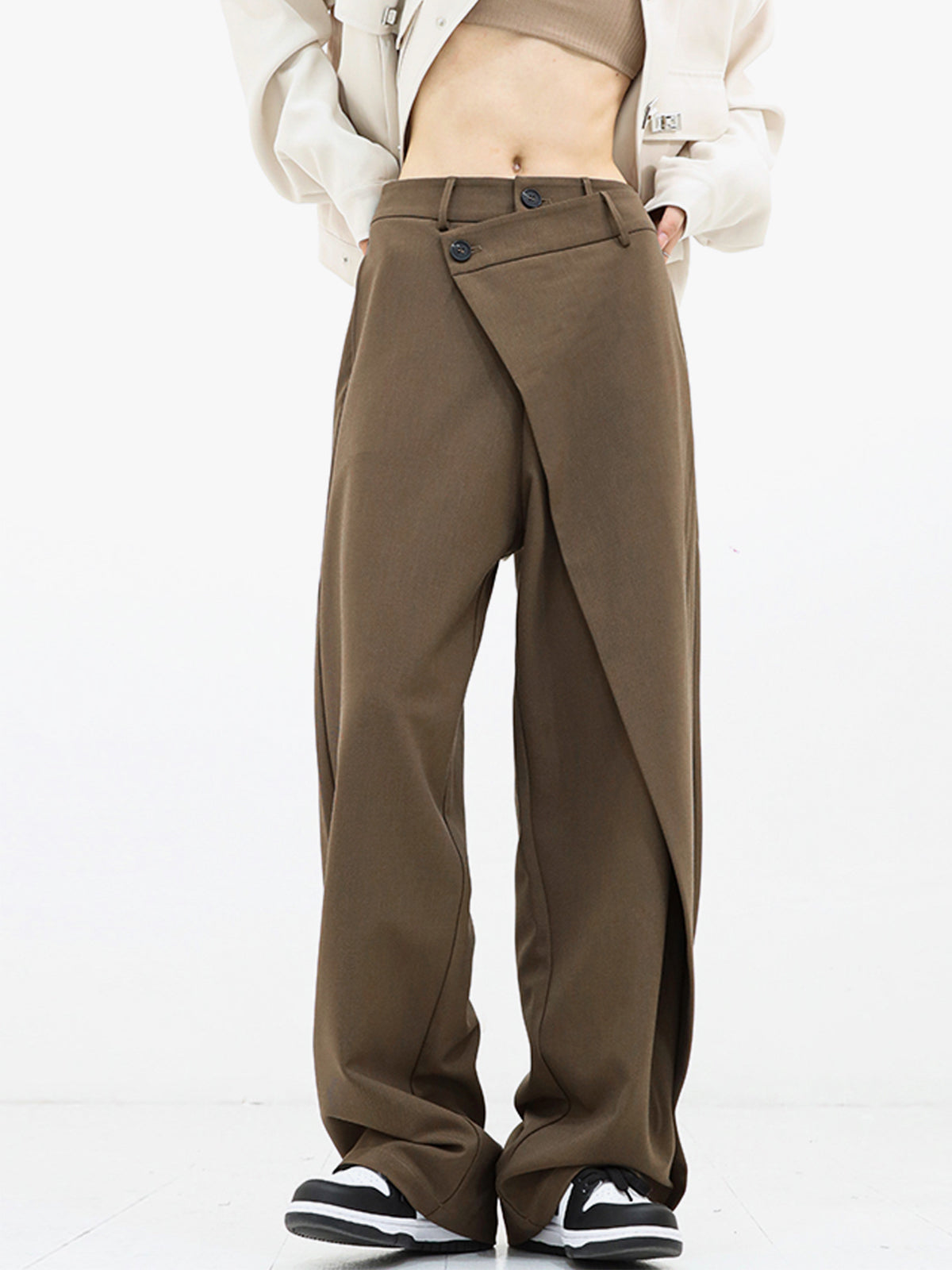 Black asymmetrical relaxed-fit pants with draped overlay and dual button closure for women