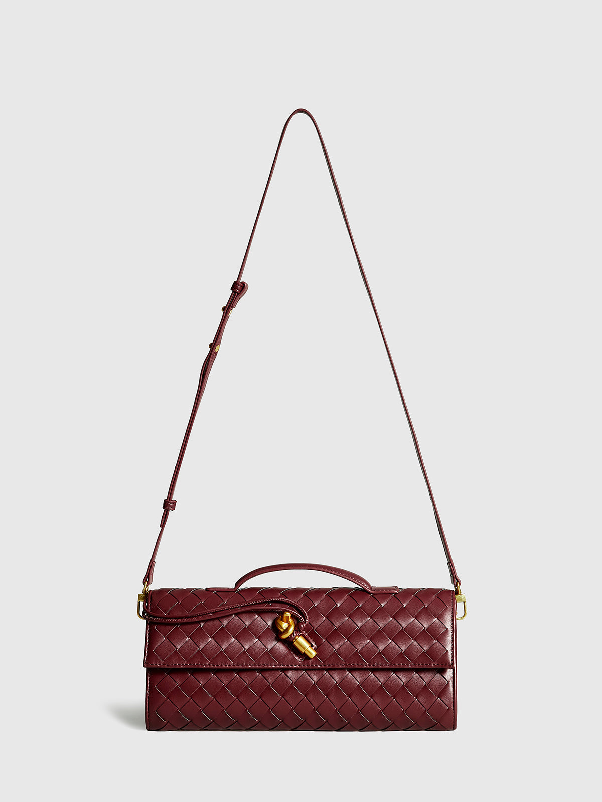 Burgundy woven flap clutch with bamboo twist lock closure, structured silhouette for dressy evenings