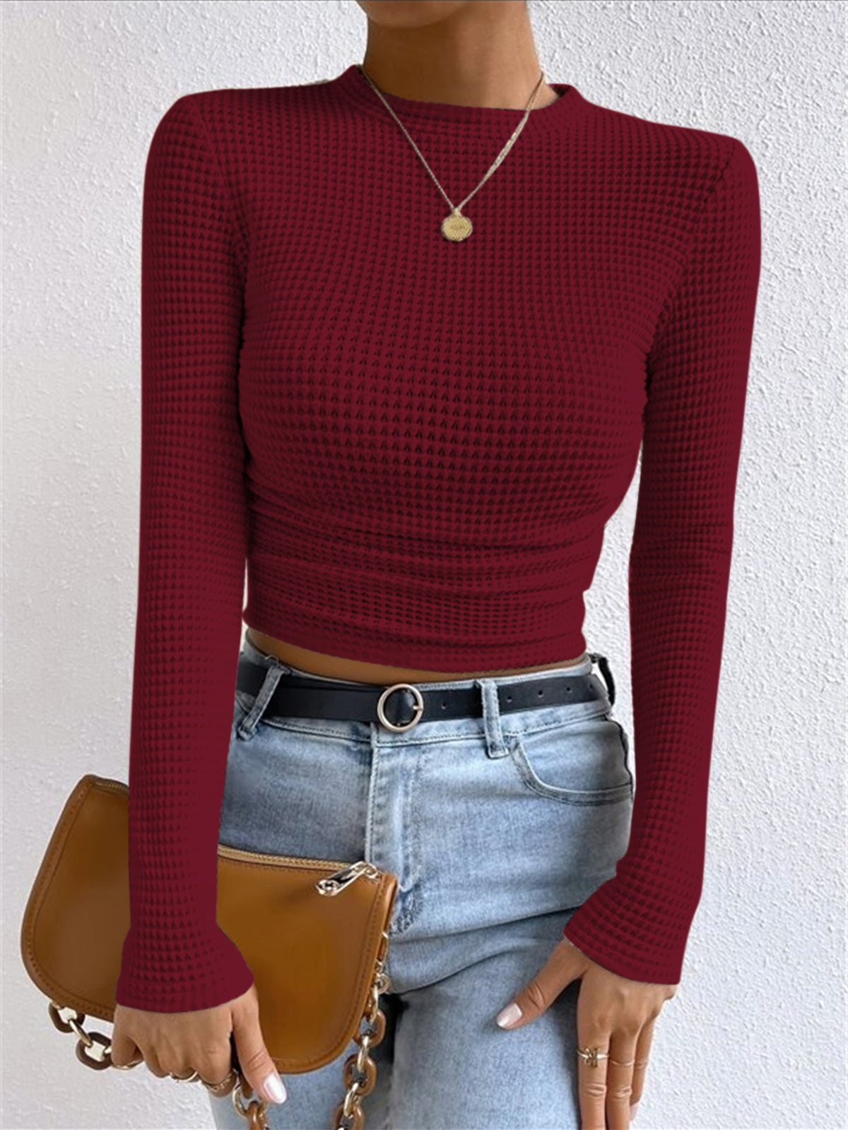Women's beige waffle knit cropped long sleeve top with contoured silhouette and grid texture
