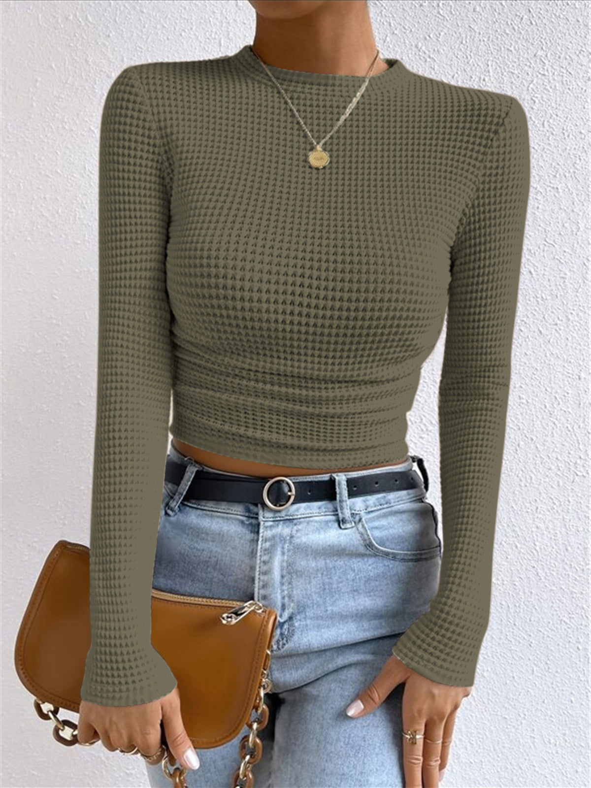 Women's beige waffle knit cropped long sleeve top with contoured silhouette and textured grid pattern