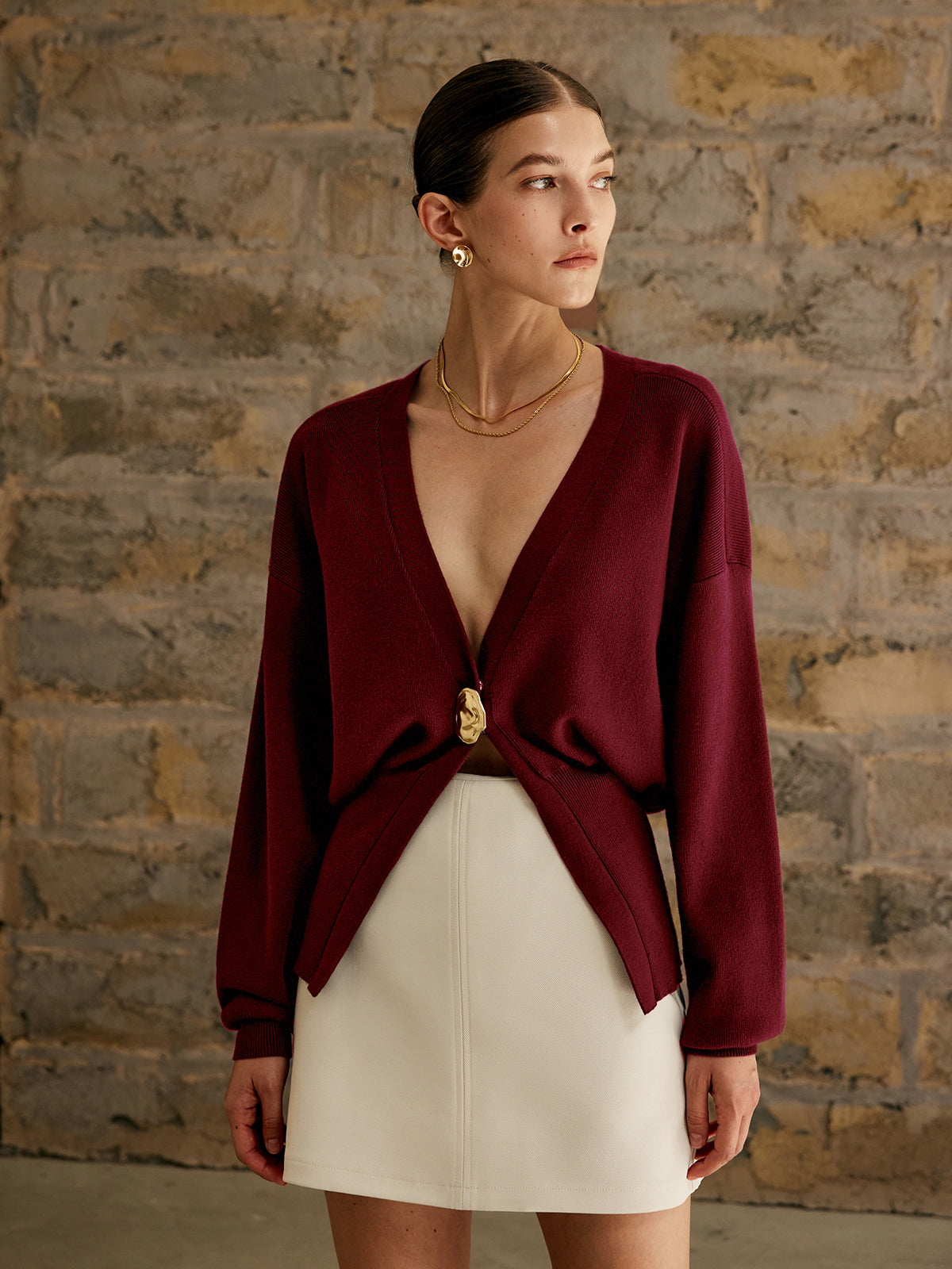 Women's solid color wool cardigan with elegant golden button closure and versatile timeless silhouette