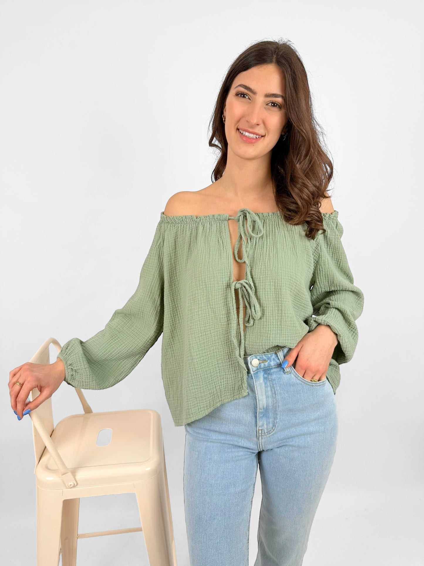 Women's white muslin blouse lightweight breathable fabric with delicate bow accents for everyday elegance