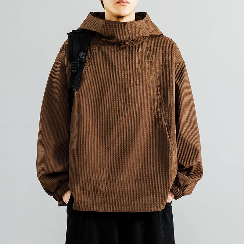 Men's oversized baggy black hoodie with textured knit fabric and relaxed streetwear silhouette