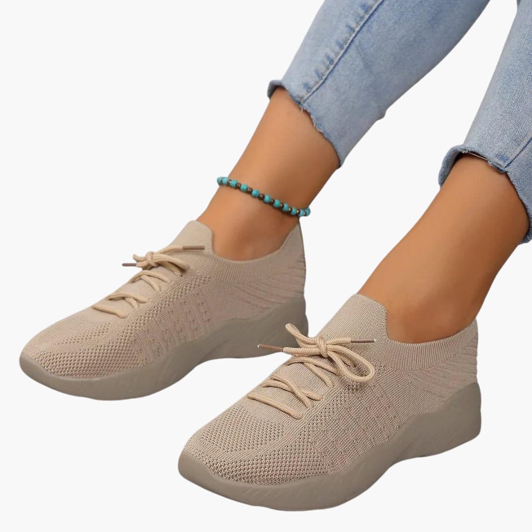 Women's white lace-up sneakers with breathable mesh upper and flexible sole for all-day comfort