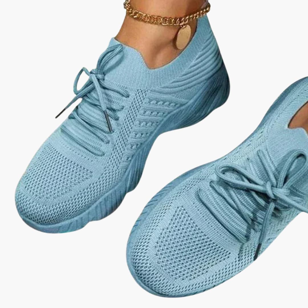 Women's white lace-up sneakers with breathable mesh upper and flexible sole for all-day support