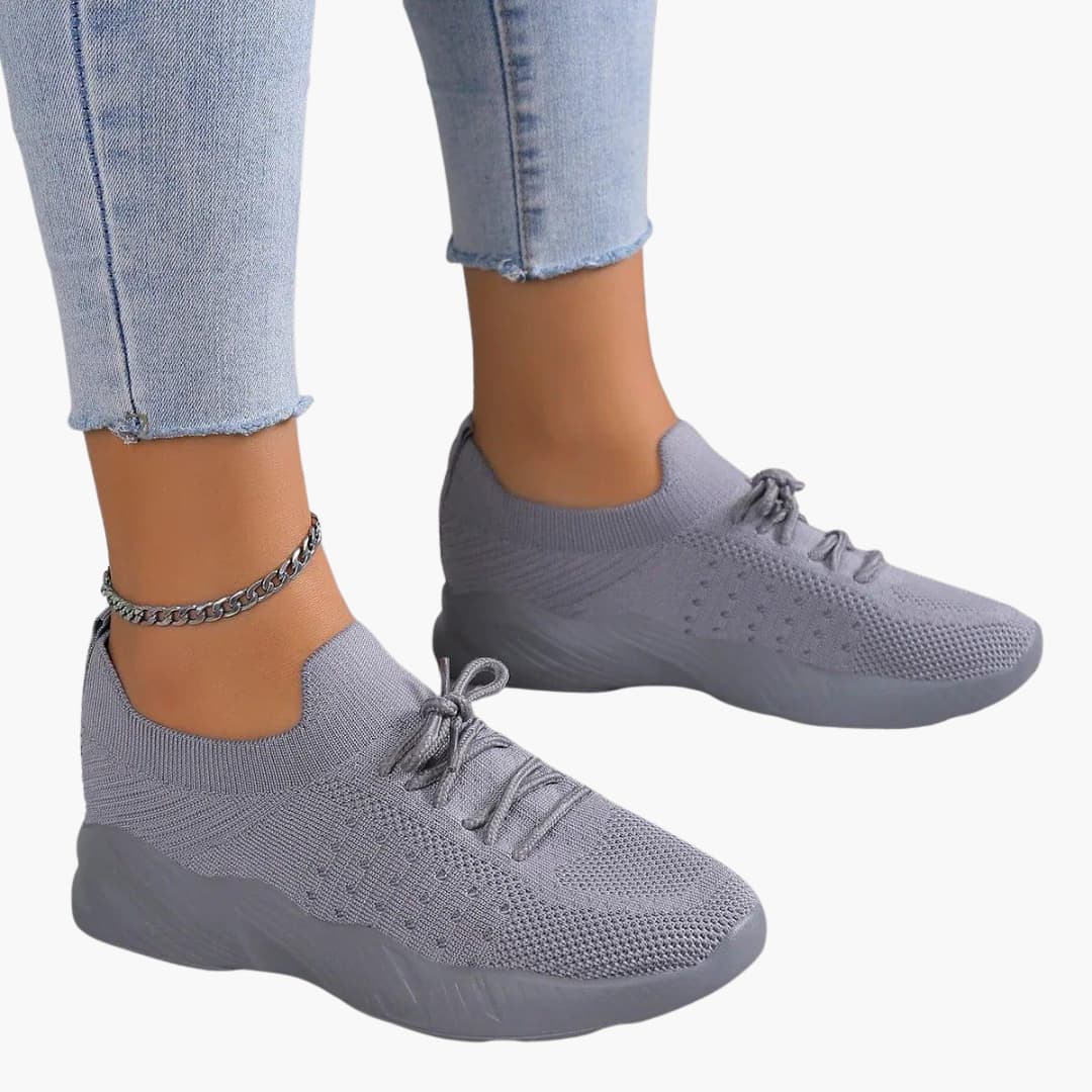 Women's white mesh lace-up sneakers with low-cut silhouette and flexible breathable sole