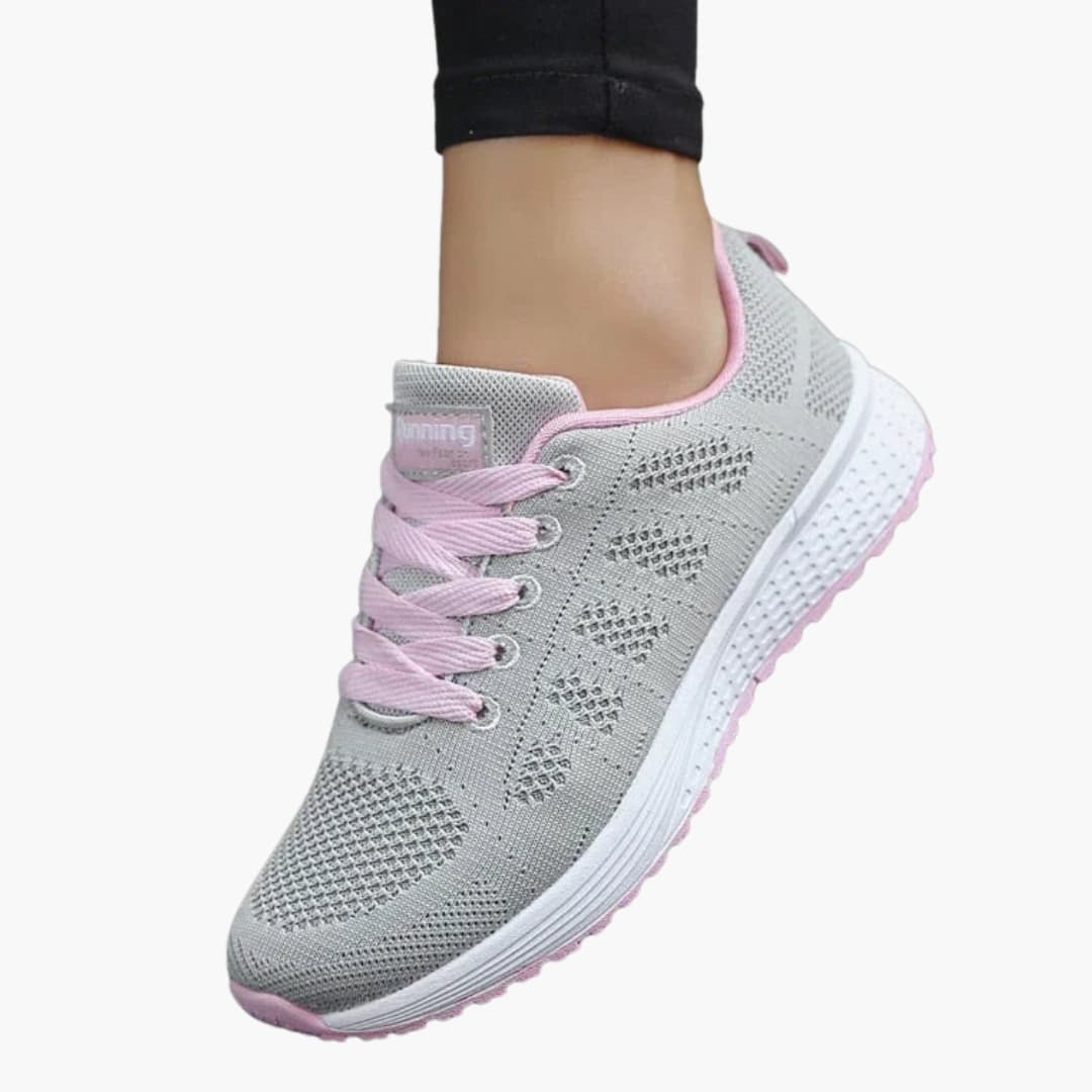 Women's white perforated sneakers with structured sole, breathable lace-up design for urban walking