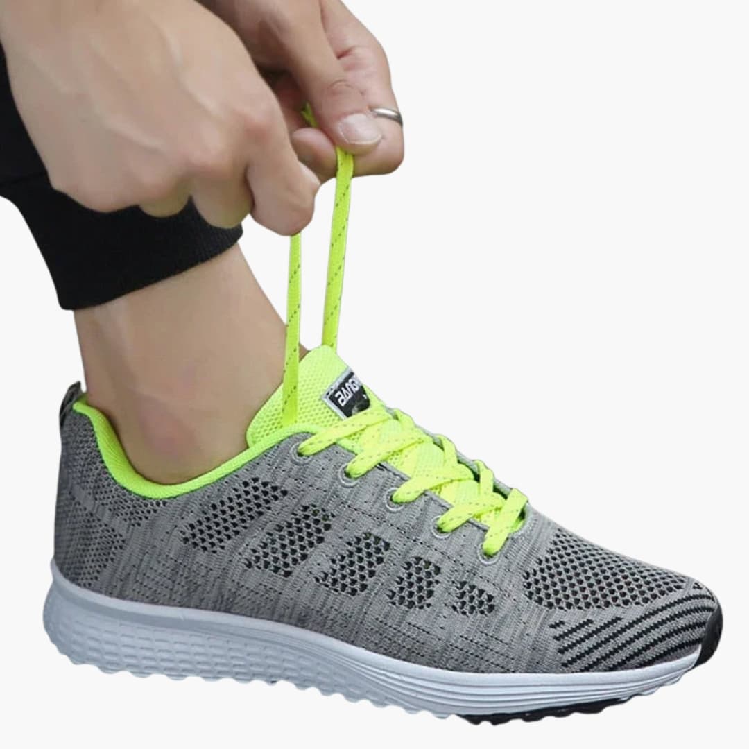 Women's white perforated sneakers with structured sole, breathable lace-up design for urban walking
