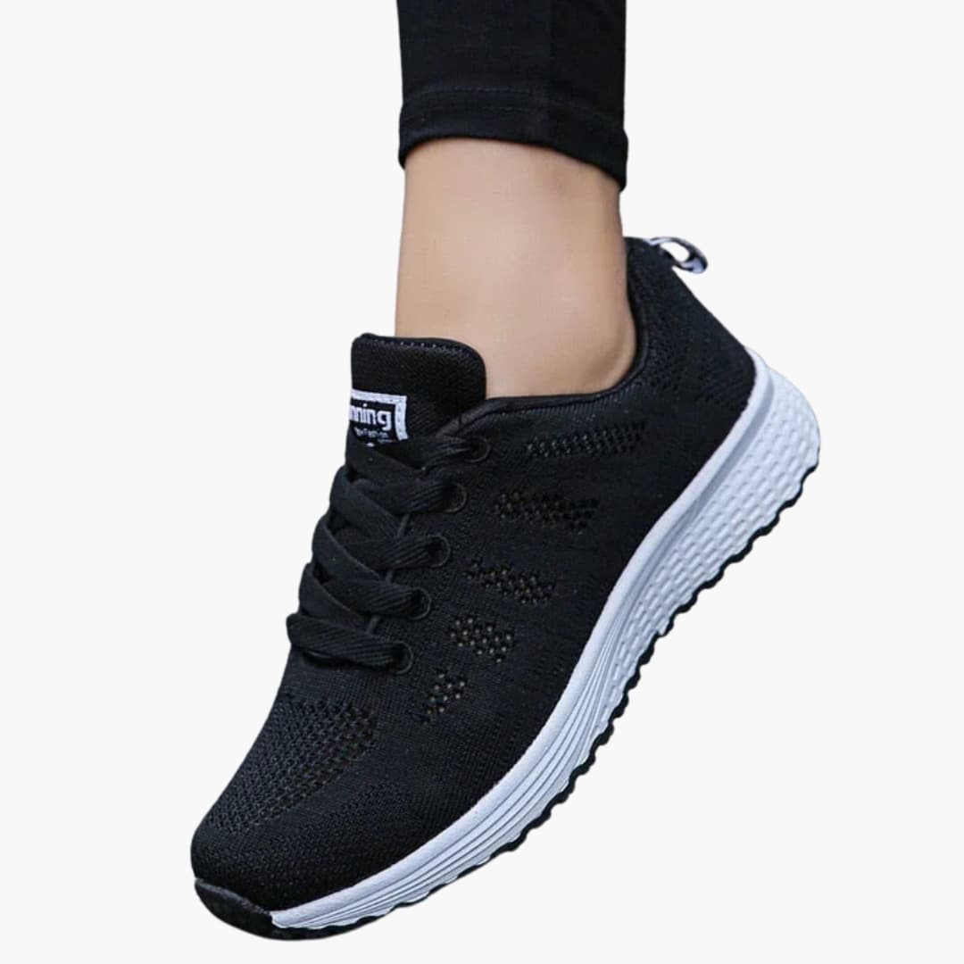 Women's white perforated sneakers with structured sole, breathable lace-up design for urban walking