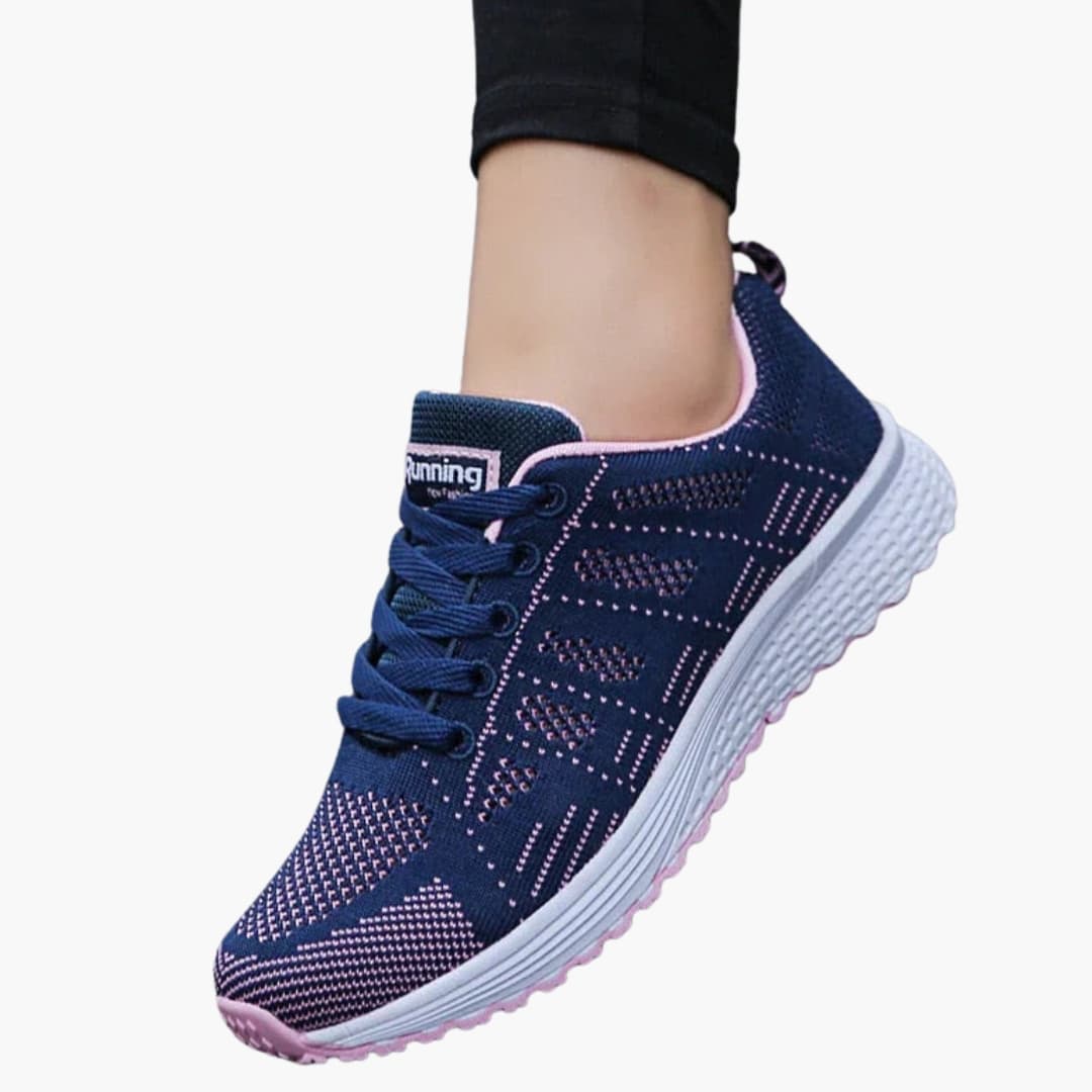 Women's white perforated sneakers with structured sole, breathable lace-up design for urban walking