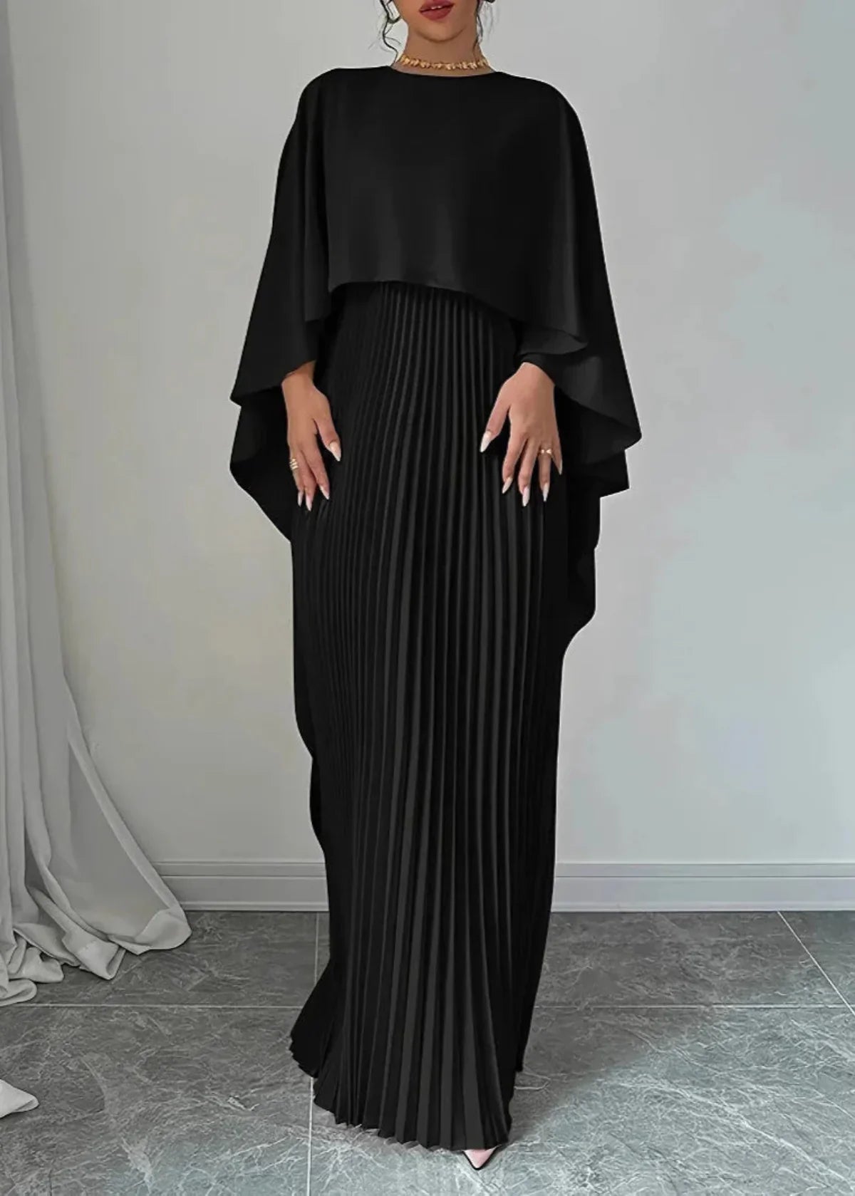 Black pleated cape overlay maxi dress with flowing skirt for elegant evening wear