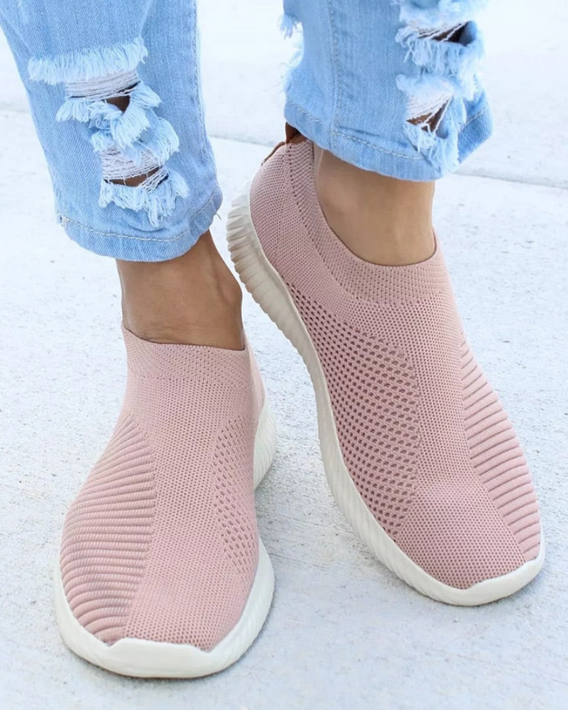 Women's white slip-on walking sneakers with stretch fit elastic upper and lightweight air-cushion sole