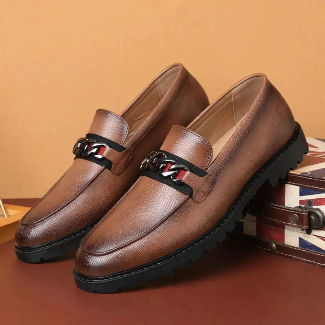 Men's textured leather loafers in classic tan with chain-link metal accent and cushioned dress-shoe silhouette